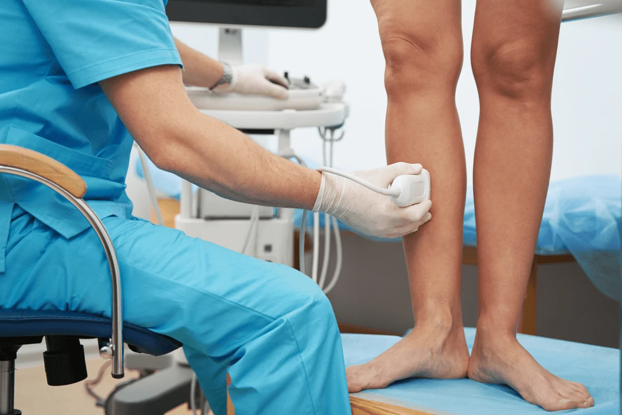 A medical professional performing a leg vein ultrasound to detect circulation issues